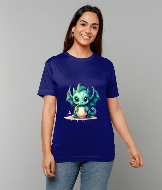 Teal cartoon baby dragon clutching a pale egg printed centered on a royal blue T-shirt worn by a smiling woman standing against a plain light gray background.