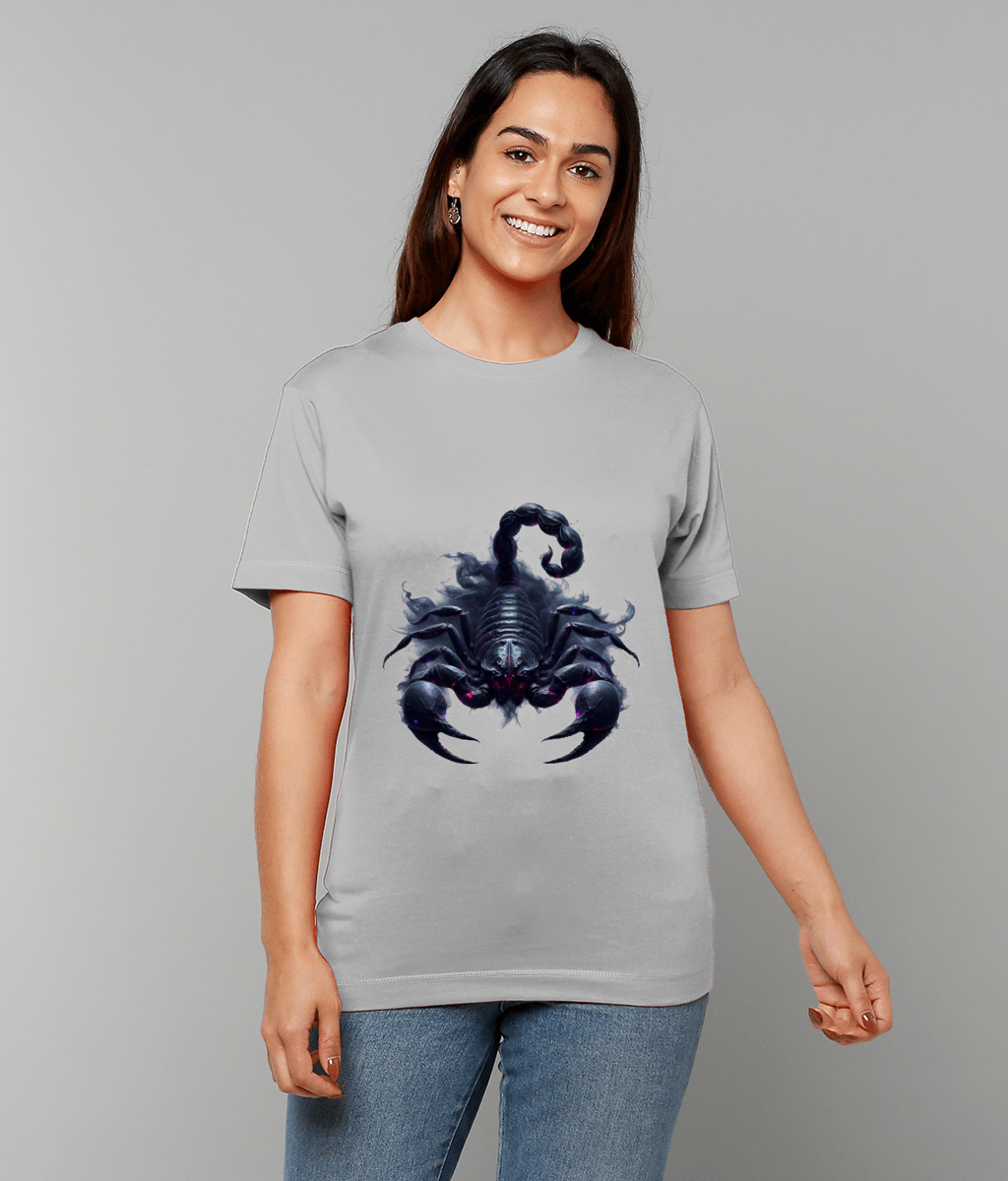 Dark stylized scorpion graphic printed on a light gray T-shirt worn by a smiling woman standing against a plain gray background, her hands relaxed by her sides.