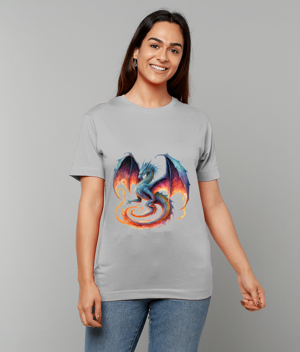 Smiling woman wears a light gray T-shirt featuring a coiled blue and turquoise dragon with flaming orange tail and wings unfurled, set against a plain gray studio background.