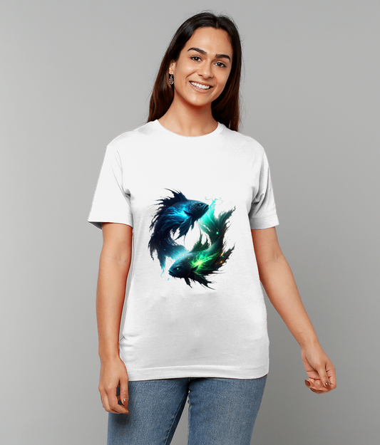 White T-shirt featuring two luminous stylized fish circling each other worn by a smiling woman standing against a plain gray background.