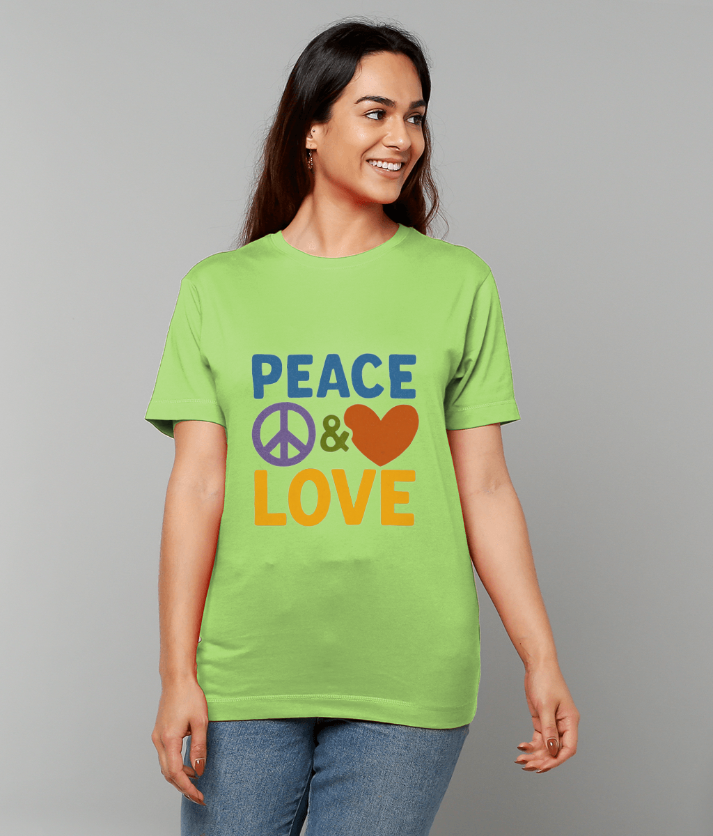Woman wearing a lime green T-shirt printed with PEACE ☮ & ♥ LOVE, smiling and looking right while standing against a plain gray background.