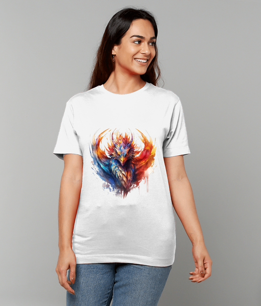 A white T-shirt with a vibrant multicolored phoenix graphic worn by a smiling woman looking right, standing against a plain gray background and wearing blue jeans.