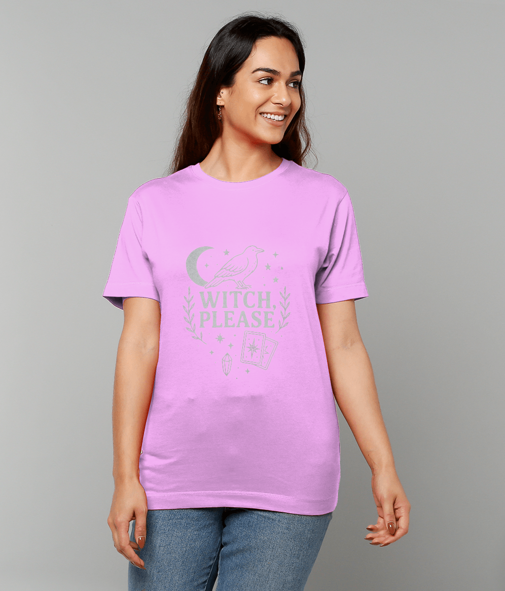 A woman wearing a pink T-shirt that reads "WITCH, PLEASE" stands smiling and looks to her right against a plain gray background.