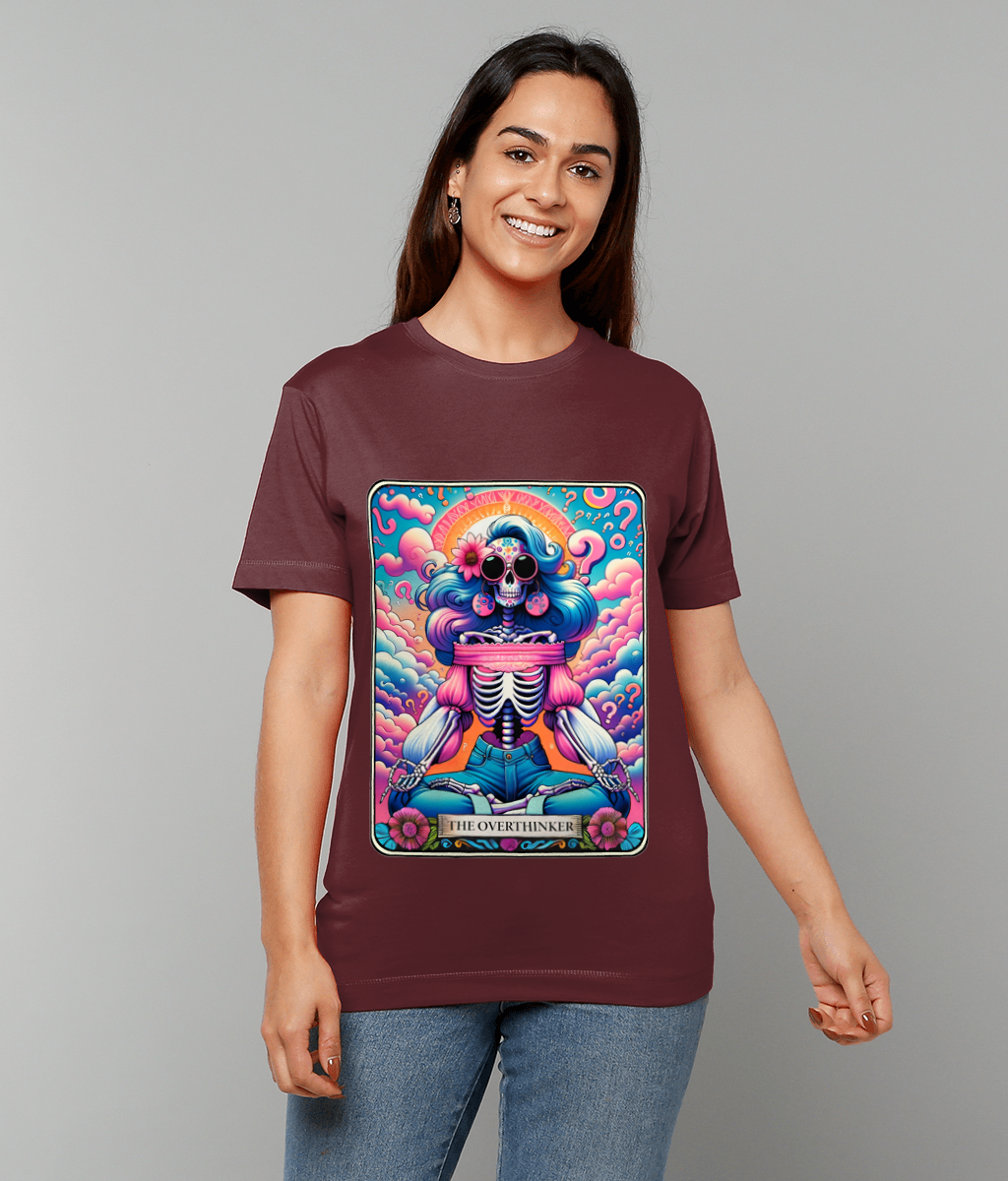 A colorful skeleton sits cross-legged in meditation on a maroon t-shirt worn by a smiling woman against a plain gray background text on the design reads THE OVERTHINKER.