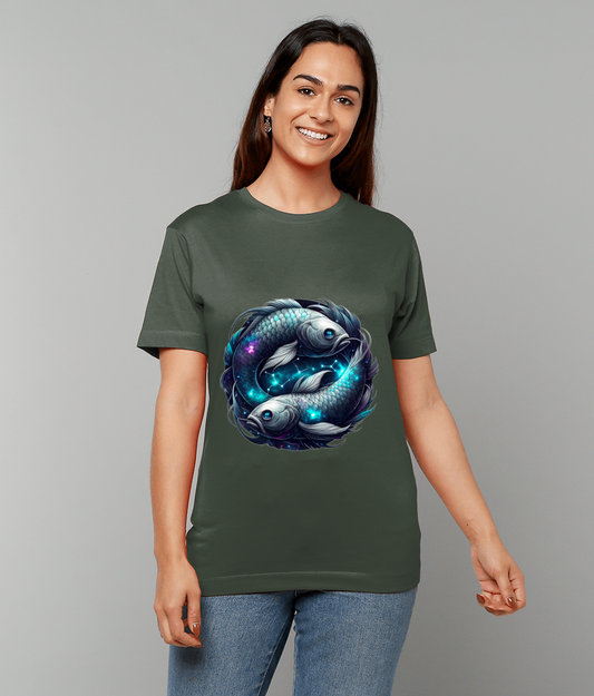 Two stylized koi fish swim in a circular yin-yang formation on a dark green T-shirt worn by a smiling person against a plain gray background.