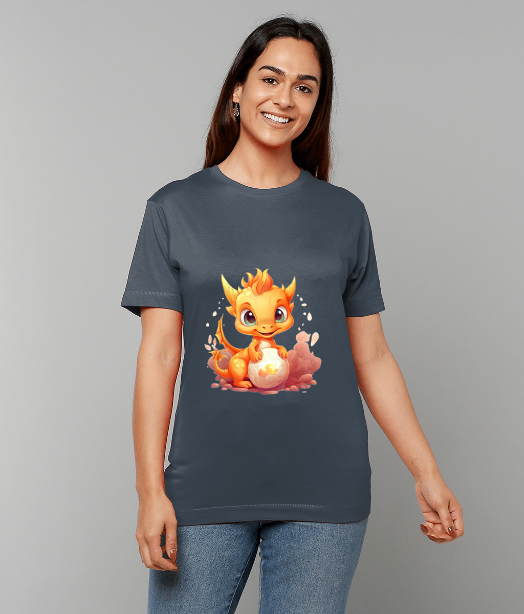 A cartoon orange dragon sits holding a glowing egg printed on a dark gray T-shirt worn by a smiling woman standing against a plain light gray background.