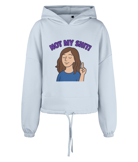 Light blue cropped hoodie displays a cartoon woman raising one finger with eyes closed; purple text above reads "NOT MY SHIT!" on a plain dark background.