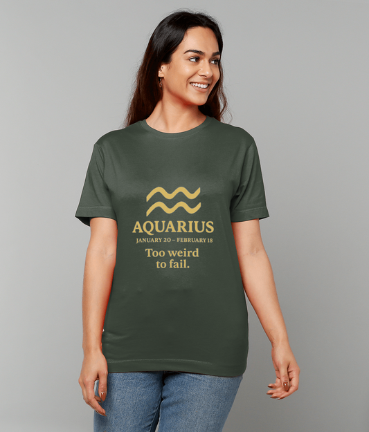 Green T-shirt features printed design reading "AQUARIUS January 20 - February 18 Too weird to fail." worn by a smiling woman standing against a plain gray background.