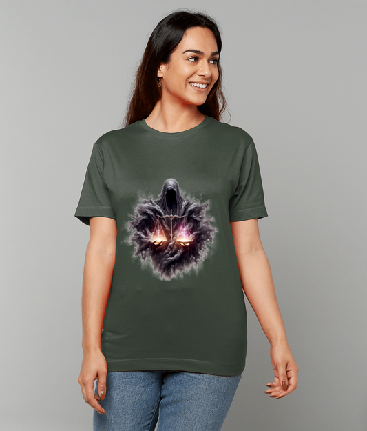 A woman smiles while wearing an olive-green T-shirt that shows a dark hooded figure holding glowing balance scales, photographed against a plain light gray studio background.