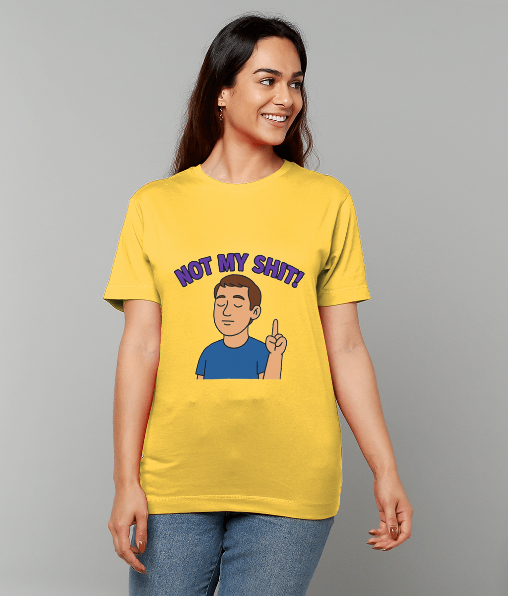 A yellow T-shirt bearing a cartoon man and bold text "NOT MY SHIT!" is worn by a smiling woman looking to the side against a plain gray studio background.
