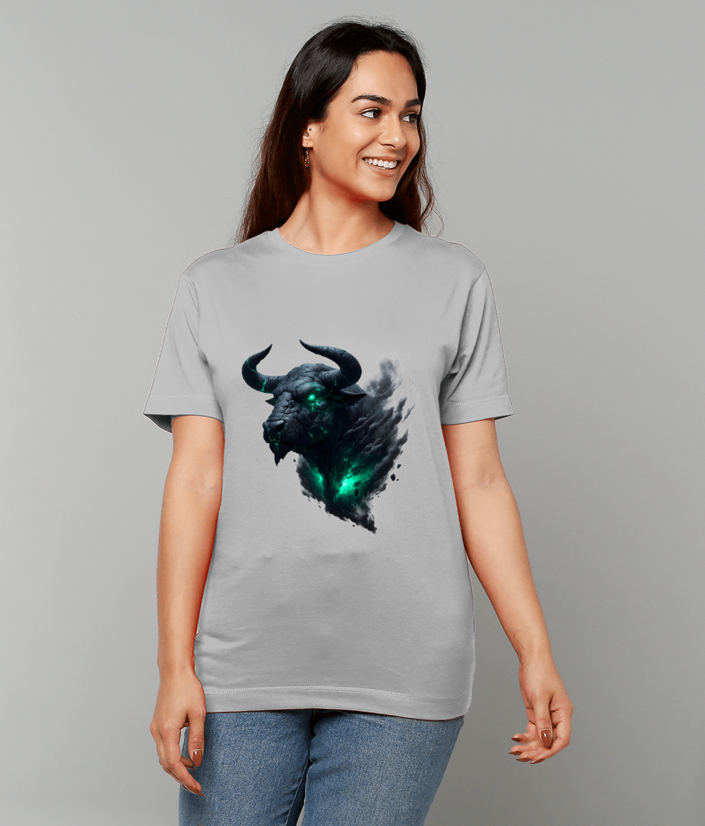 Spectral bull head printed on a light gray T-shirt worn by a smiling person; the bull glows emerald from eyes and chest amid smoky dark wisps against a gray background.