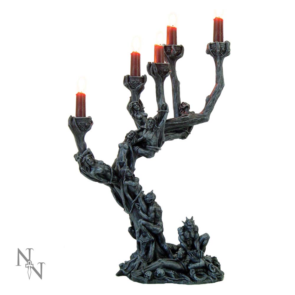 A gargoyle candelabra holds five lit red candles. The gray stone candelabra is formed from intertwined figures.