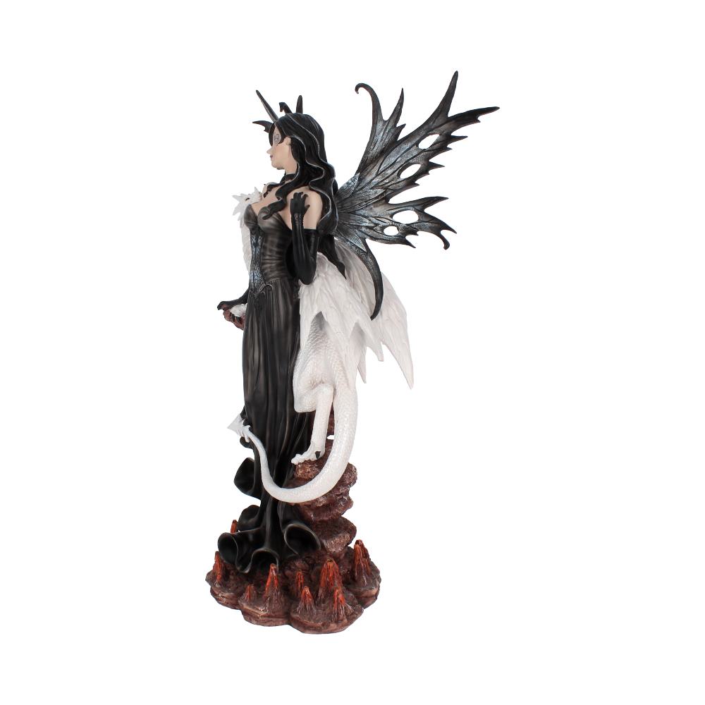 A fairy statue stands with a white dragon at her side, posed on a rocky, fiery surface. The fairy wears a black dress and has black, jagged wings and horns.
