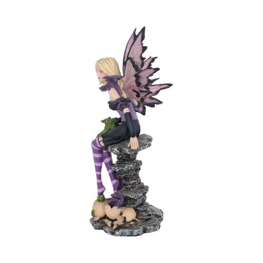 A blonde, winged fairy wearing purple striped leggings sits on a grey rock formation. A green dragon is curled up next to her, and hatched dragon eggs are below.