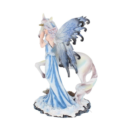 The figurine depicts a winged fairy in a blue gown, her hand to her face, standing next to a unicorn with a gold horn on a rocky base.