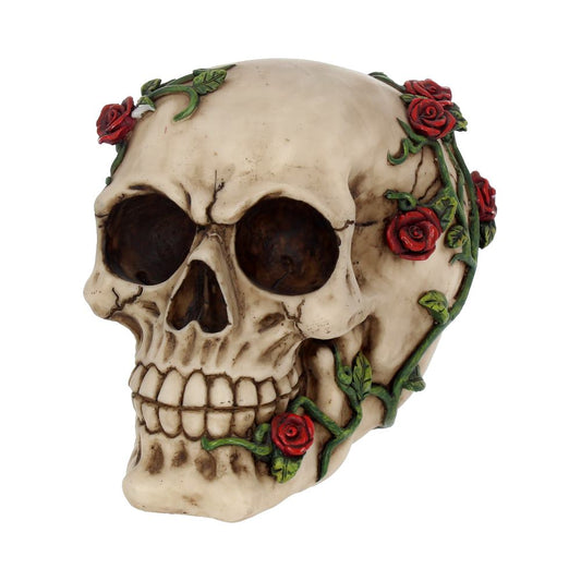 Skull wrapped in green vine with red roses, facing three-quarter left, showing hollow eye sockets and teeth against a plain white background.