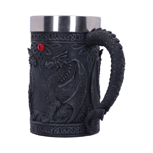 A dark-colored mug with a metal interior features an embossed dragon design with a curled tail handle. It’s set against a white background.