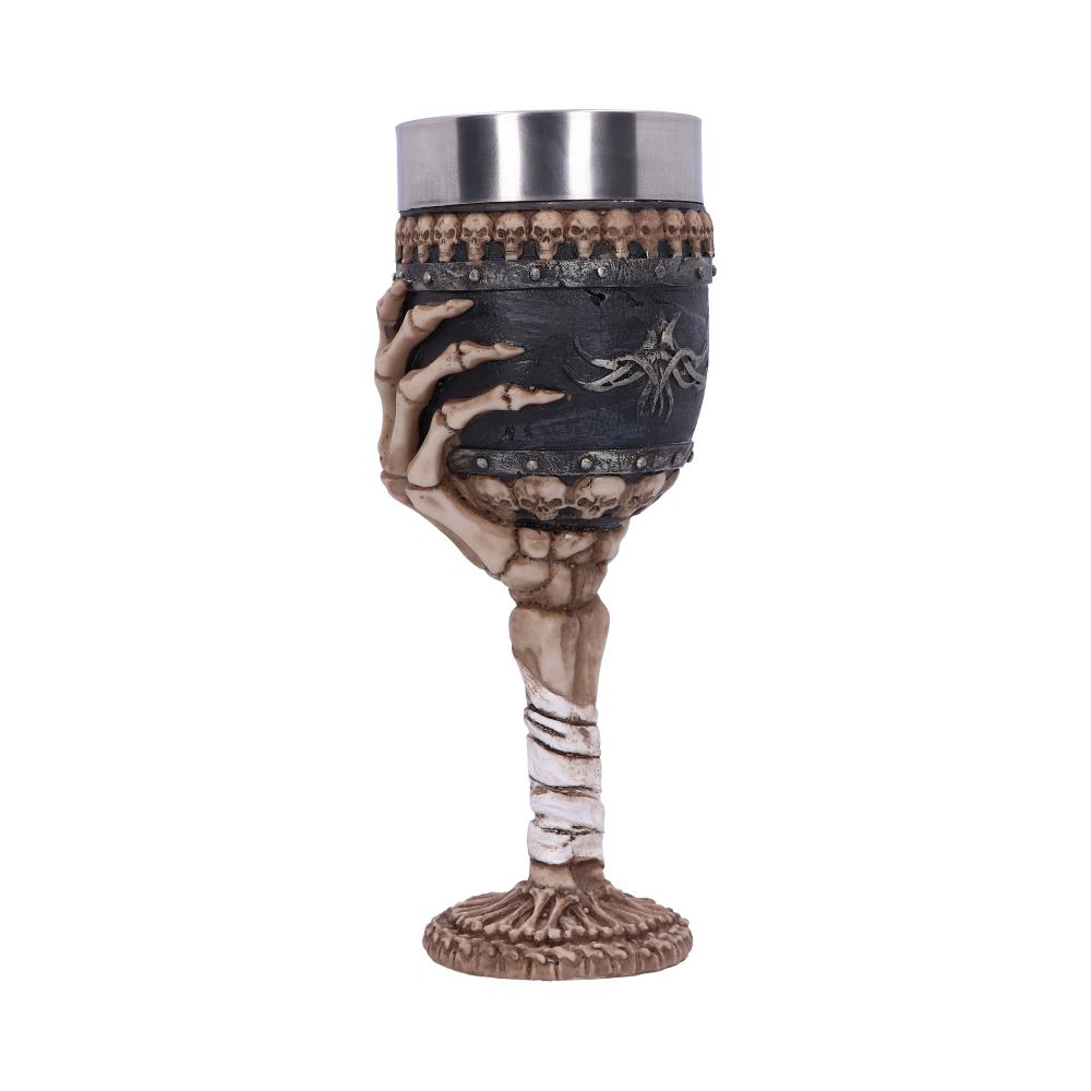 A skull-decorated goblet is gripped by a sculpted skeletal hand, the stem wrapped in bandages and skull motifs encircling the cup, set against a plain white background.