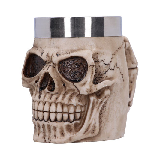 A skull-shaped ceramic mug with a silver stainless steel rim, featuring detailed carvings and a realistic texture, appears against a plain white background.