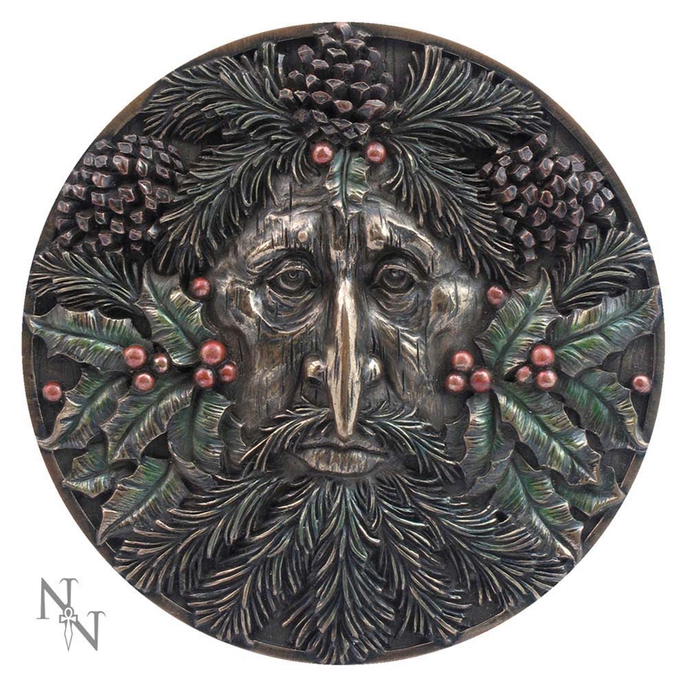 A circular plaque features a face crafted from leaves, berries, and pinecones, with foliage as hair and beard. The initials "N" and "W" are in the bottom left corner.