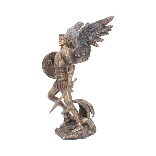 Bronze statue of Saint Michael standing over a vanquished dragon with sword drawn, shield in hand, and wings spread. The base reads "ST. MICHAEL".