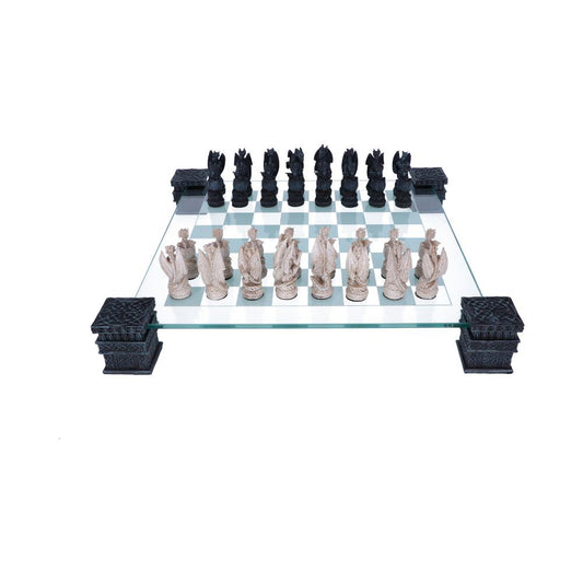 A dragon chess set sits on a glass board, supported by ornate, dark-colored pillars. The pieces are arranged for the start of a game.