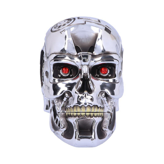 A metallic skull with red eyes is facing forward. It appears mechanical with intricate details and bolts. The backdrop is plain white, enhancing its futuristic and robotic appearance.