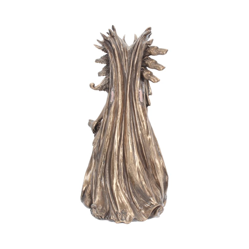 A bronze-toned sculpture depicts a figure wearing a long, flowing cloak adorned with animal heads. It stands isolated against a white background, creating a dramatic and mysterious appearance.