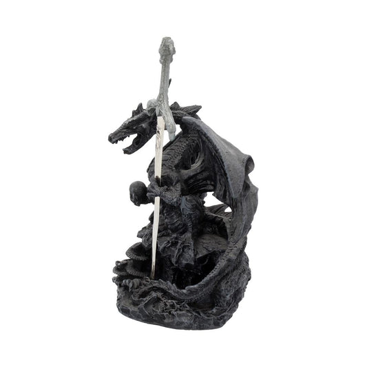 A black dragon figurine holds a silver sword, perched on a rocky base.
