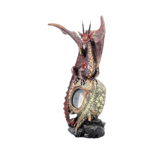 A detailed red dragon figurine towers over a decorative clock, perched on a rock-like base. The dragon has large wings spread majestically behind it, creating a striking fantasy theme.