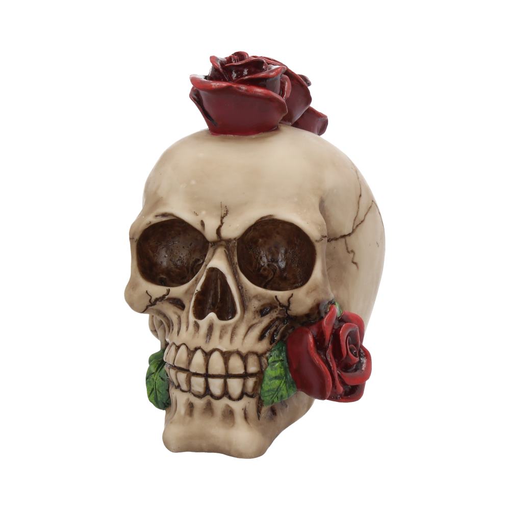 A skull figurine adorned with red roses rests atop it and on the side, set against a plain white background. Everything is intricately detailed, highlighting a blend of lifelike and artistic elements.