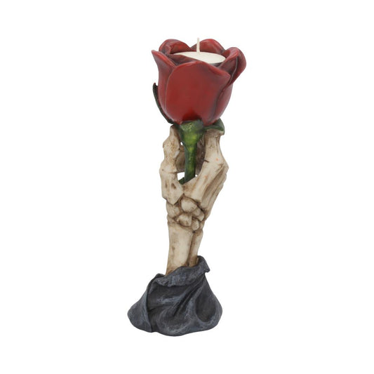 Red rose-shaped candle cradled by a weathered skeletal hand above a draped dark base, standing upright against a plain white background.