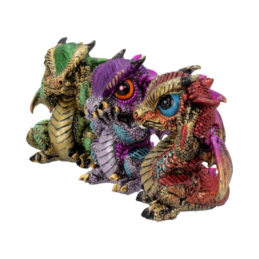 Three colorful dragon figurines sit closely together. The first is green and gold, the second purple and silver, and the third red and blue, displaying intricate scales and vivid eyes.