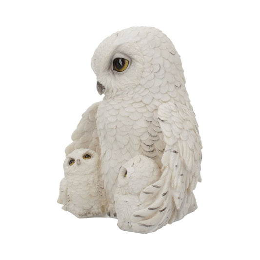 A white owl figurine envelops two smaller owlets with its wings, symbolizing protection. The sculpture displays detailed feather texture against a plain, neutral background.
