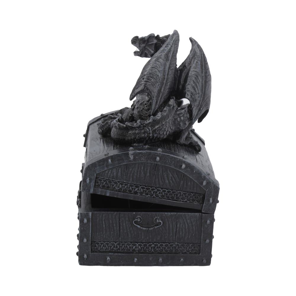 A detailed black dragon figurine perches atop a wooden-texture treasure chest with Celtic patterns, partially open. The setting suggests a fantasy-themed decorative object.