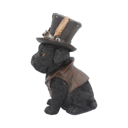 A black dog figurine sits wearing a brown vest and an embellished top hat with goggles and a feather, against a plain white background.