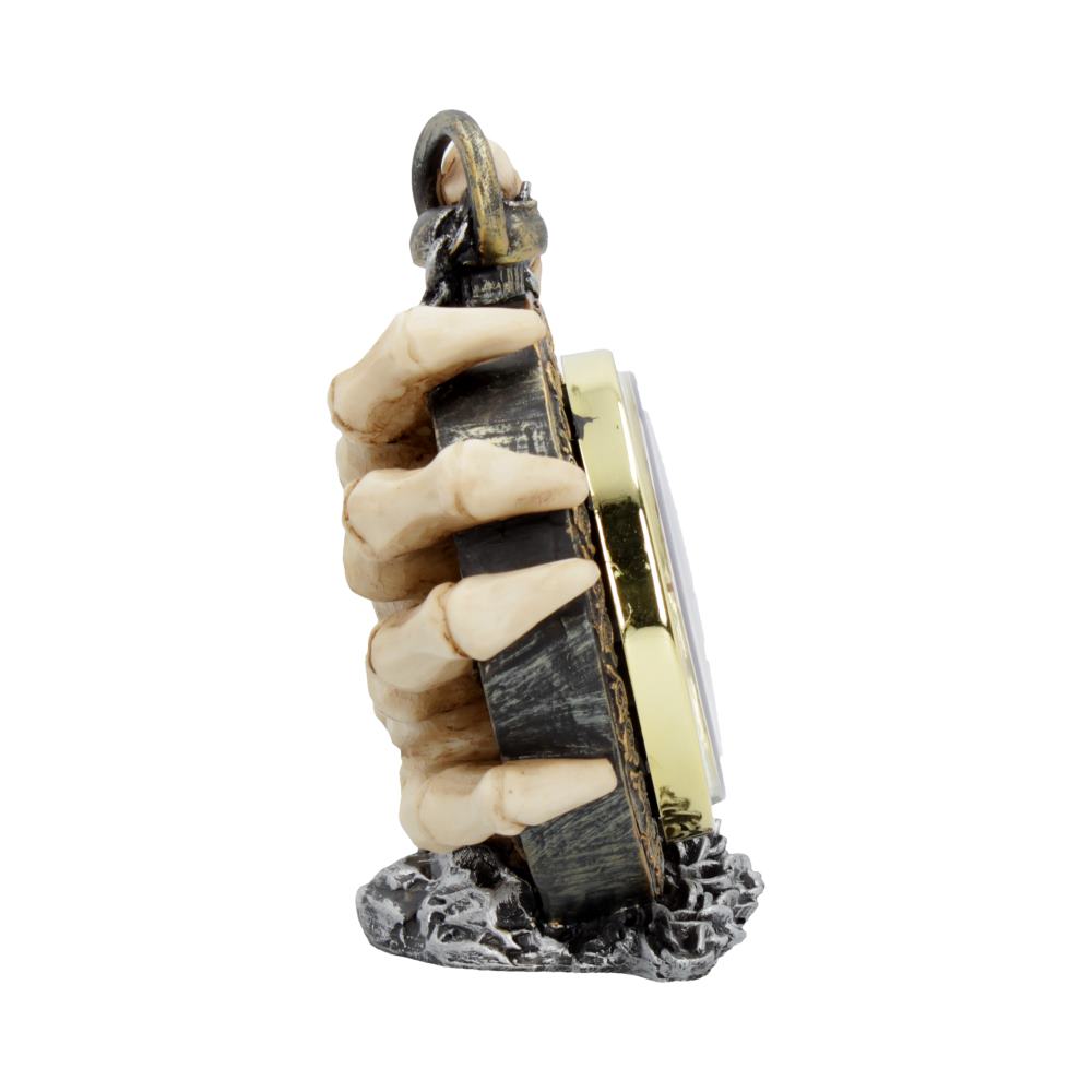 A skeletal hand holds a dark, gold-rimmed clock, standing on a rocky base against a white background.