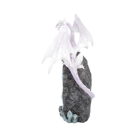 A white, intricately detailed dragon perches elegantly atop a textured gray rock, surrounded by small blue crystal-like formations.