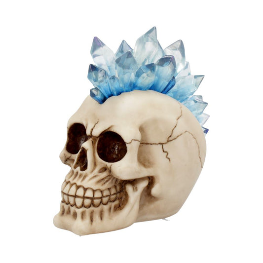 A human skull sculpture, adorned with vibrant blue crystals protruding from the top, sits against a plain white background.