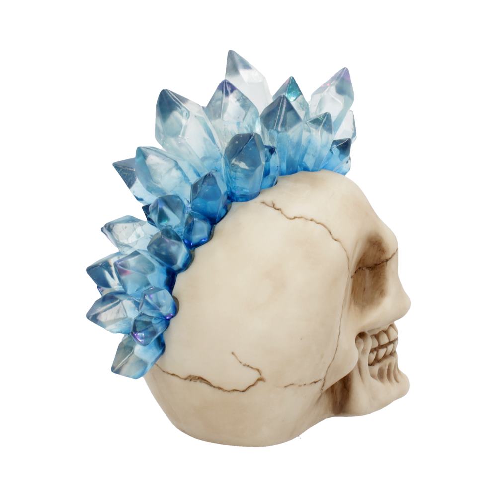 A side view of a human skull decorated with vibrant blue crystals along the top, placed against a plain white background, showcasing intricate textures and reflective surfaces.