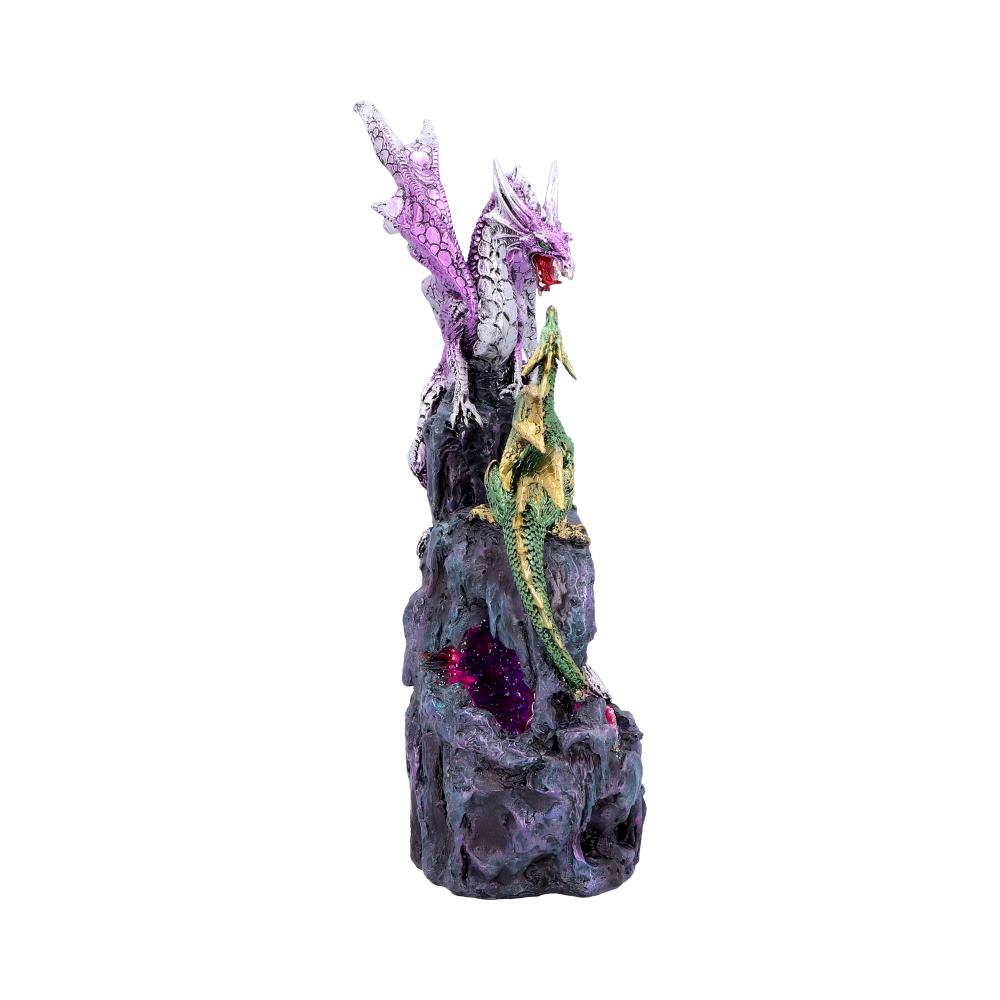 A purple dragon stands atop a rocky outcrop, wings spread, while a green dragon climbs below. The scene features colorful rocks, creating a mystical setting.