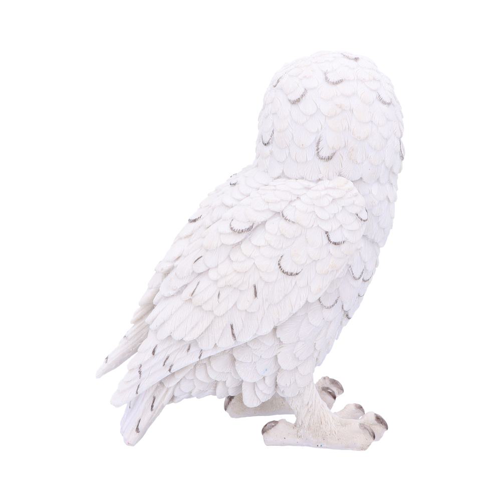 A white owl figurine stands still, showcasing detailed, textured feathers with light gray spots, positioned against a plain white background.