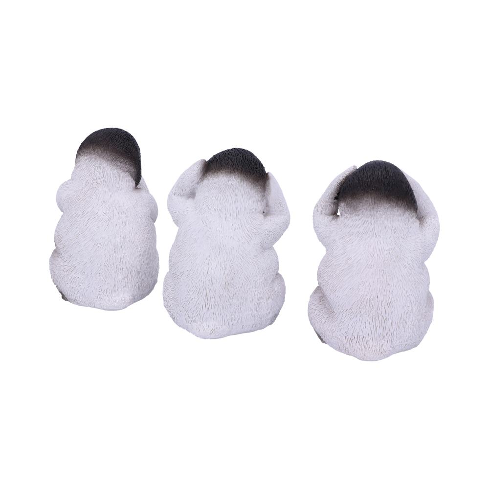 Three white, textured pug figurines are seated with their backs facing forward; one covers its ears, another its eyes, and the third its mouth, depicting the "see no evil, hear no evil, speak no evil" concept.