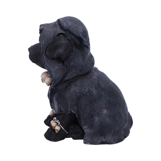 A black puppy figurine, sitting and wearing a hood with bone details, is set against a plain white background.