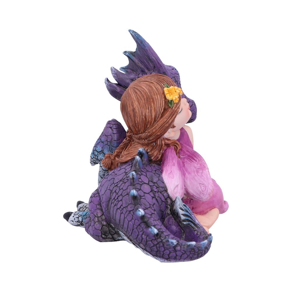 A figurine of a young girl dressed in pink with a floral hair accessory rests against a purple dragon with intricate scales, both facing away. The background is plain white.