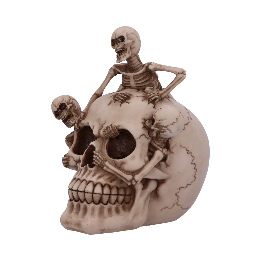 A large skull serves as a base while three small skeletons are perched atop it, seemingly interacting in various poses against a plain white background.