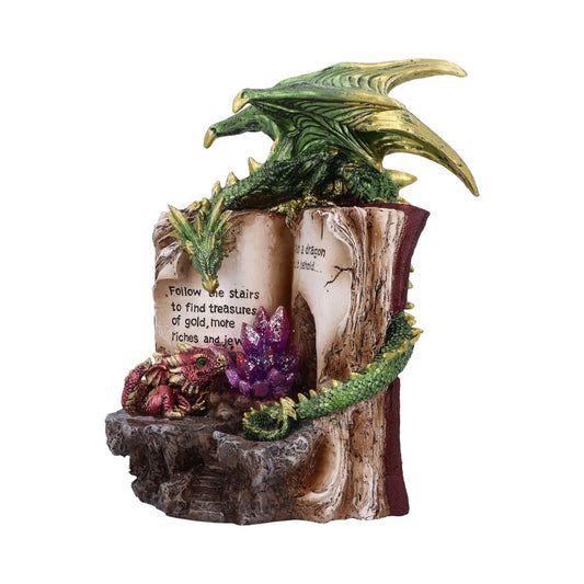 A green dragon rests atop an open book with inscriptions. Text reads: "Follow the stairs to find treasures of gold, more riches and jewels. Be a dragon and behold...". Bright crystals decorate the base.