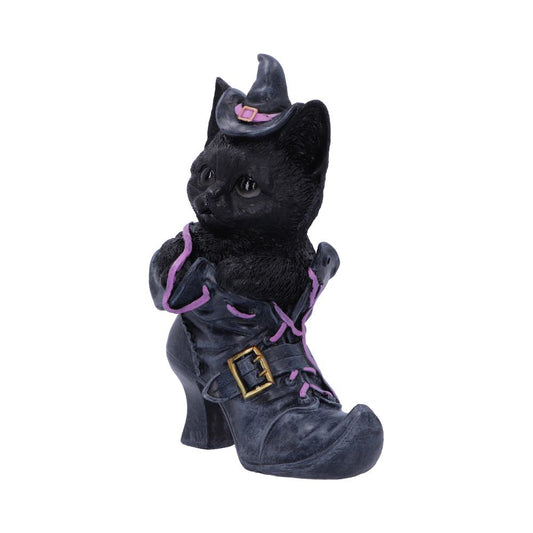 A black cat figurine wearing a witch's hat sits inside a large, worn boot with purple laces. The boot features a prominent buckle. The background is plain white.