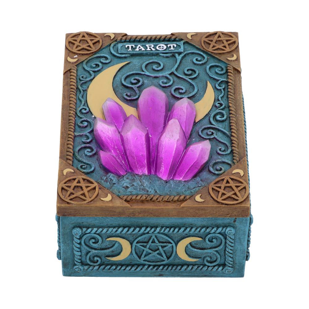 Box adorned with purple crystal cluster and crescent moon; embossed with "TAROT" on an intricately designed blue and brown surface featuring pentagrams and swirling patterns.