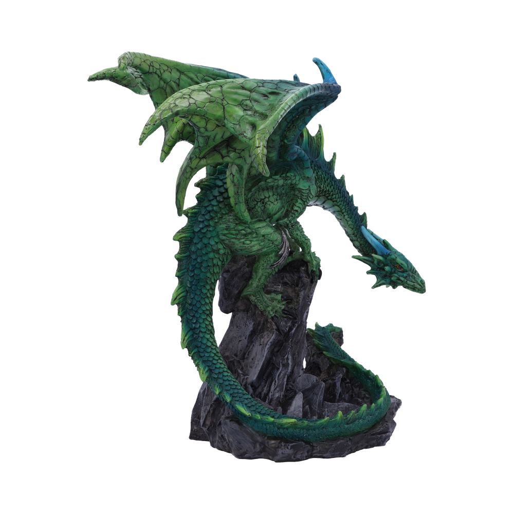A detailed green dragon figurine perches on a rocky outcrop, poised with wings extended. The dragon's scales and textures are highly defined, conveying a sense of mythical grandeur.
